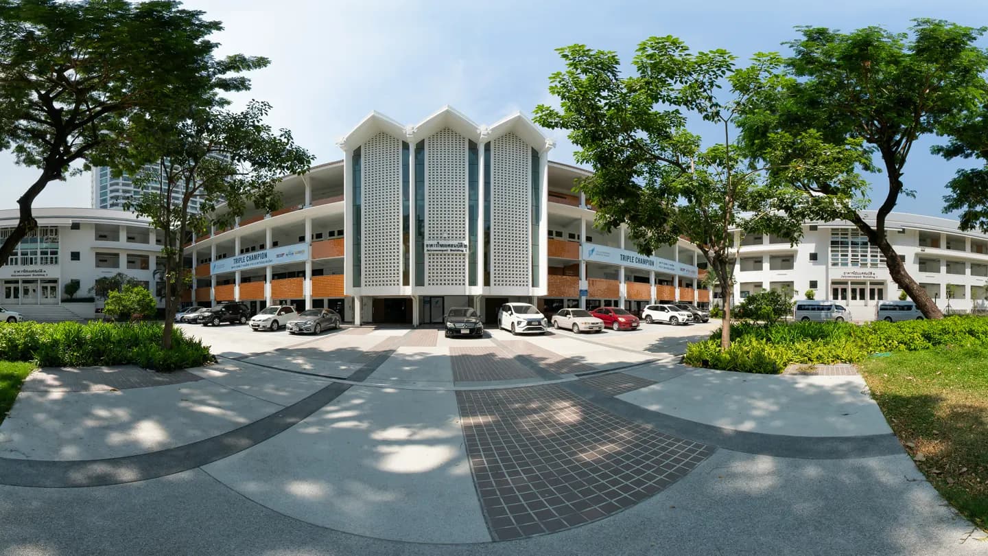 Chulalongkorn Business School entrance framed by trees and landscaped grounds