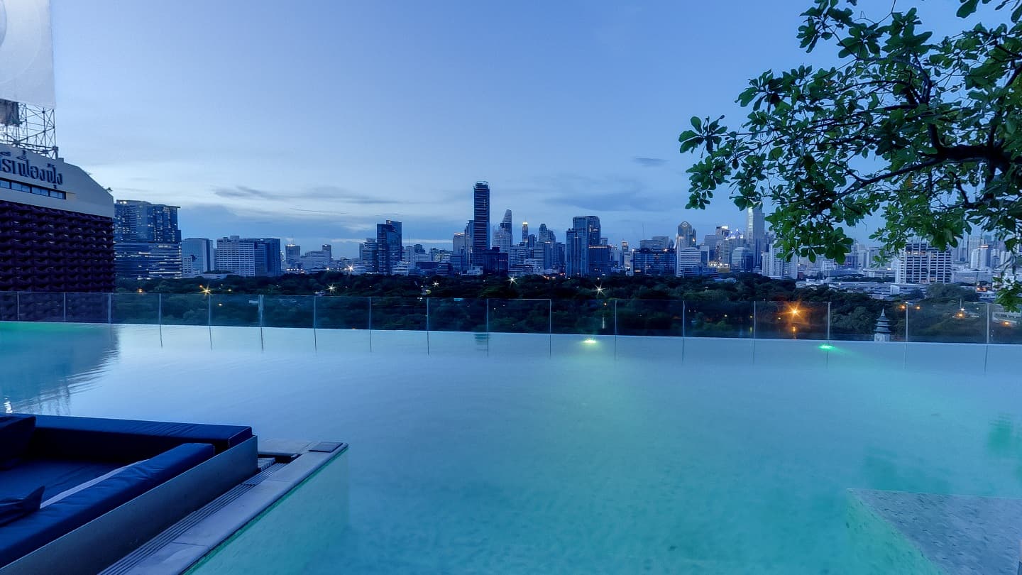 Hotel infinity pool overlooking the Bangkok skyline at dusk