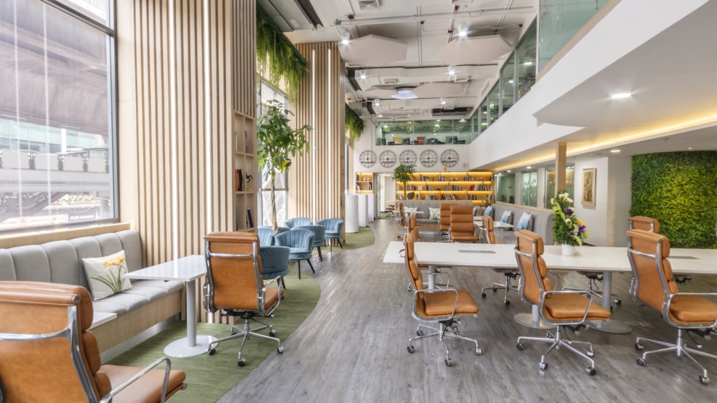 Bright coworking space with timber furniture, planting and a mezzanine