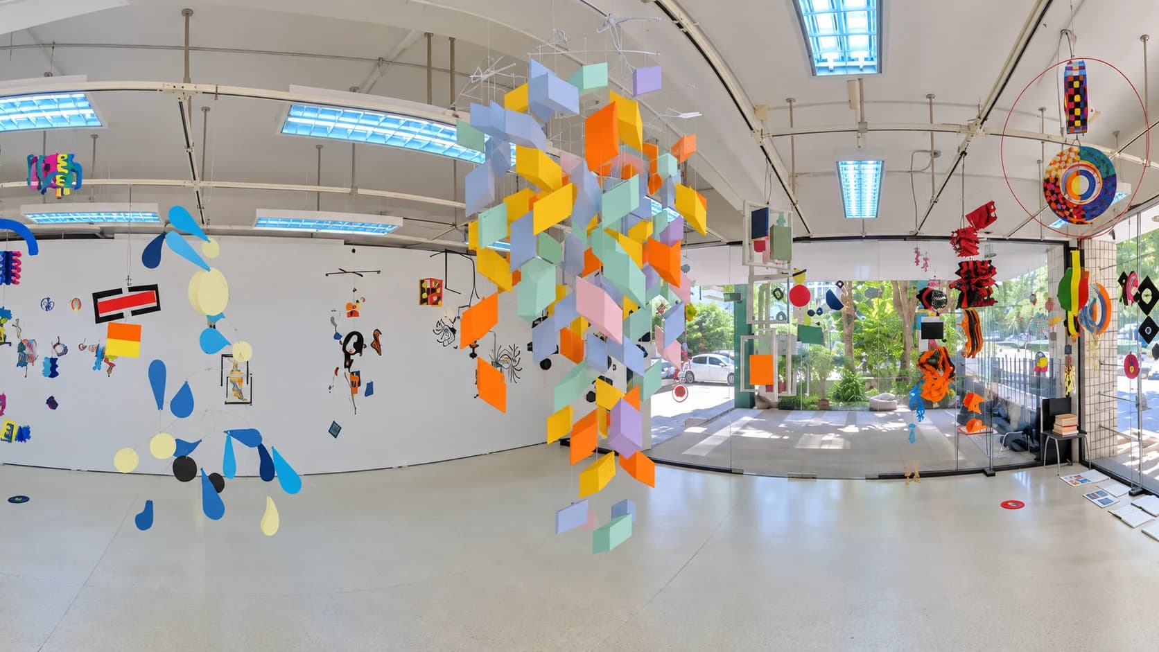 Colorful hanging paper mobiles in a bright gallery