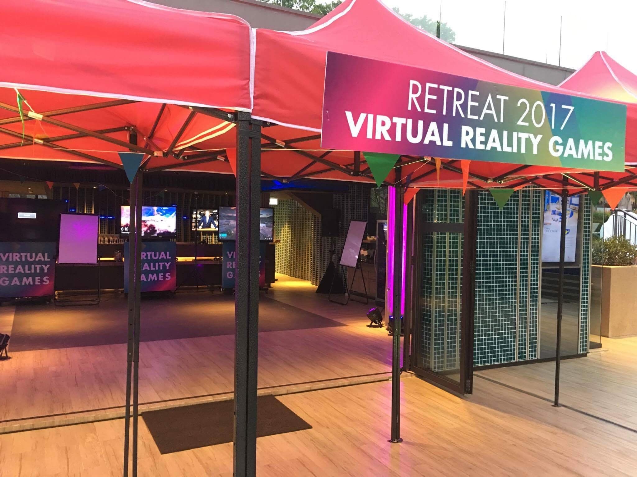 The entrance to the VR arcade, with a Retreat 2017 Virtual Reality Games sign above the red tents.