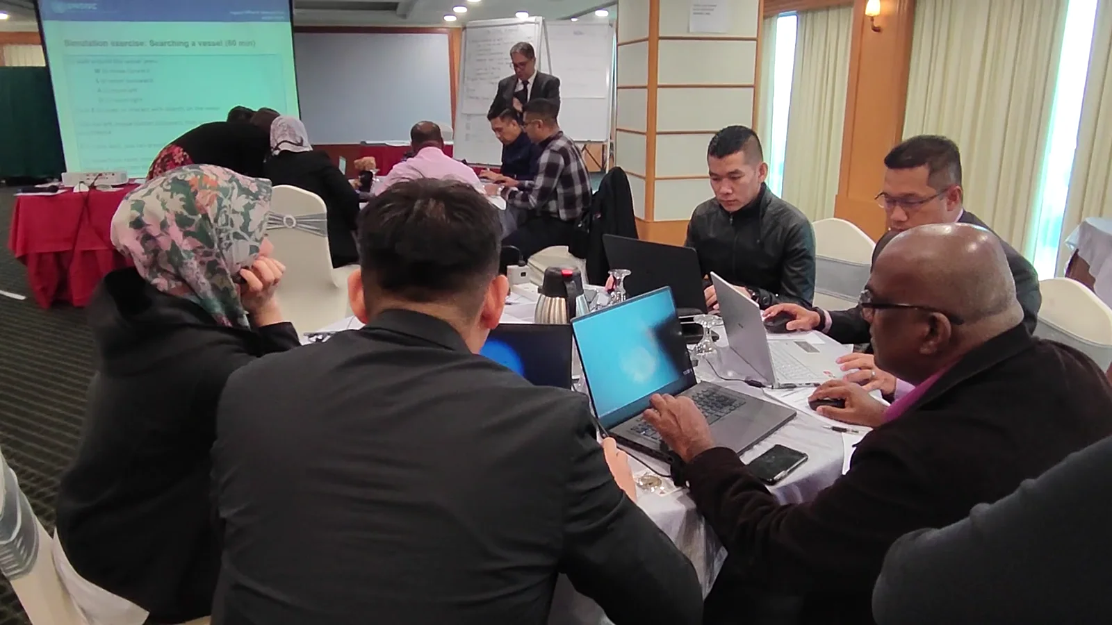 Participants using the vessel-search simulation on laptops in Penang, February 2023.