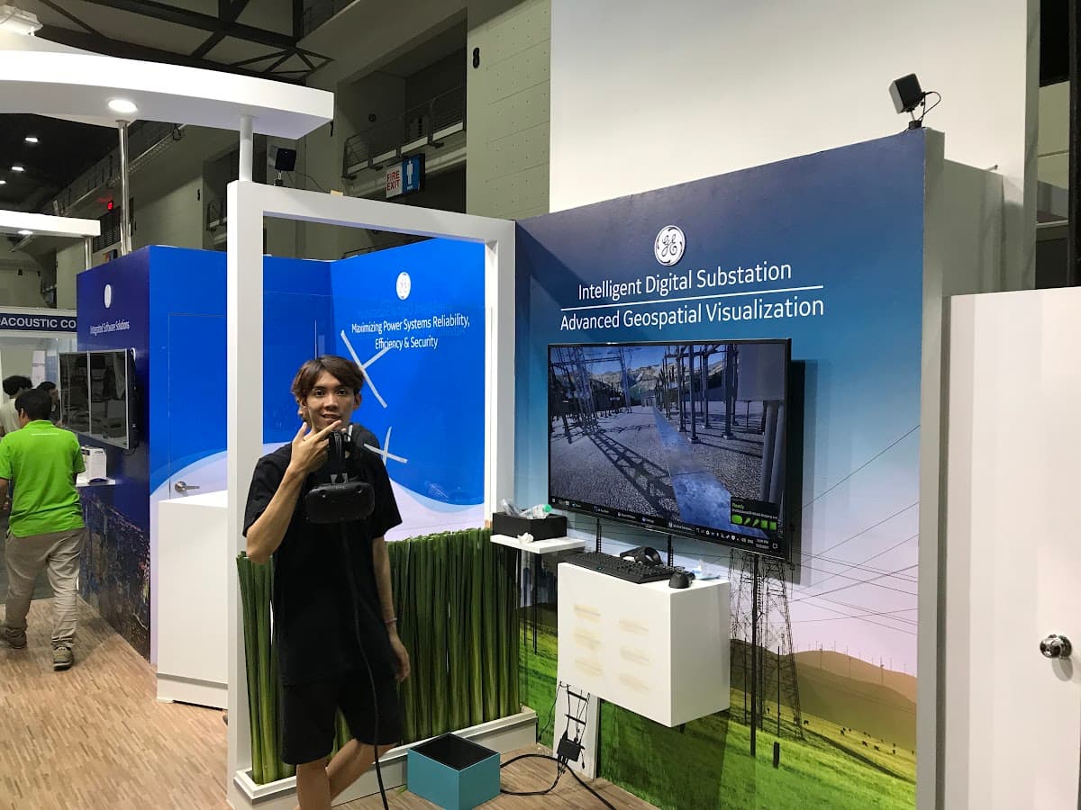 General Electric's digital-substation exhibition stand with a VR headset, mounted tracking sensors and a large display showing the virtual substation, May 2017.
